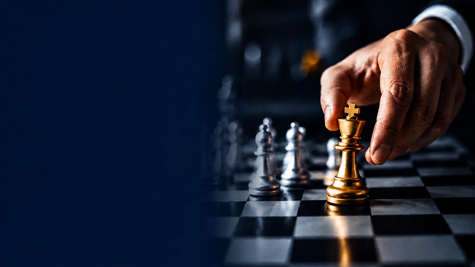A hand moving a gold king across a chessboard.